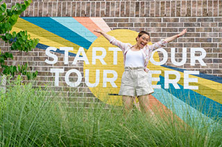 Girl jumping up in air at Elyson Welcome Center in Katy, TX